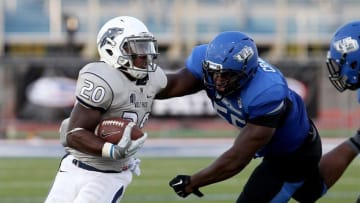Sep 26, 2015; Buffalo, NY, USA; Buffalo Bulls defensive lineman Brandon Crawford (55) tackles Nevada Wolf Pack running back James Butler (20) during the second half at University of Buffalo Stadium. Nevada beats Buffalo 24-21. Mandatory Credit: Timothy T. Ludwig-USA TODAY Sports