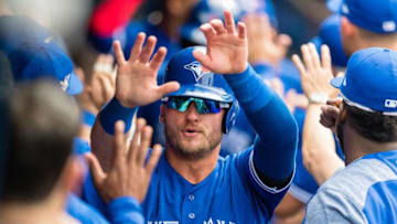 Josh Donaldson #20 of the Toronto Blue Jays celebrates after scoring off a single by Yangervis Solarte #26 during the fourth inning against the Cleveland Indians at Progressive Field on May 3, 2018 in Cleveland, Ohio. All players are wearing #42 in honor of Jackie Robinson Day in this makeup game from April 15. (Photo by Jason Miller/Getty Images)