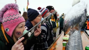 Nov 30, 2014; Green Bay, WI, USA; Fans take a shot before game between the Green Bay Packers and New England Patriots at Lambeau Field. Mandatory Credit: Benny Sieu-USA TODAY Sports