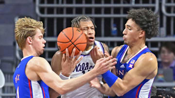 MANHATTAN, KS - JANUARY 17: Keyontae Johnson #11 of the Kansas State Wildcats battles for the ball against Gradey Dick #4 and Jalen Wilson #10 of the Kansas Jayhawks, in the first half at Bramlage Coliseum on January 17, 2023 in Manhattan, Kansas. (Photo by Peter Aiken/Getty Images)