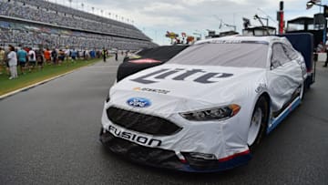 Jul 2, 2016; Daytona Beach, FL, USA; NASCAR Sprint Cup Series drivers cars sit on the grid in the rain prior to the Coke Zero 400 at Daytona International Speedway. Mandatory Credit: Jasen Vinlove-USA TODAY Sports