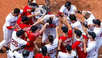 BOSTON, MA - JULY 14: Xander Bogaerts #2 of the Boston Red Sox is mobbed by teammates after hitting a walk-off grand slam home run during the tenth inning of a game against the Toronto Blue Jays on July 14, 2018 at Fenway Park in Boston, Massachusetts. (Photo by Billie Weiss/Boston Red Sox/Getty Images)