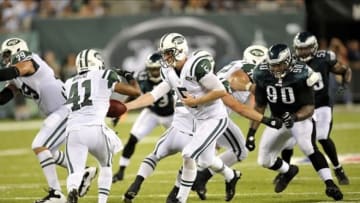 Aug 29, 2013; East Rutherford, NJ, USA; New York Jets quarterback Matt Simms (5) hands off to running back Mossis Madu (41) during the second half of a preseason game at Metlife Stadium. The Jets won 27-20. Mandatory Credit: Joe Camporeale-USA TODAY Sports