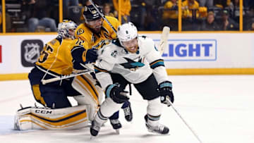 May 5, 2016; Nashville, TN, USA; San Jose Sharks center Joe Pavelski (8) attempts to play the puck against Nashville Predators center Mike Fisher (12) during the third overtime period in game four of the second round of the 2016 Stanley Cup Playoffs at Bridgestone Arena. The Predators won 4-3. Mandatory Credit: Aaron Doster-USA TODAY Sports