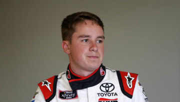 INDIANAPOLIS, INDIANA - SEPTEMBER 06: Christopher Bell, driver of the #20 Rheem/Parker Hannifin Toyota, stands in the garage area during practice for the NASCAR Xfinity Series Indiana 250 at Indianapolis Motor Speedway on September 06, 2019 in Indianapolis, Indiana. (Photo by Brian Lawdermilk/Getty Images)