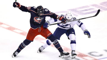 Pierre-Luc Dubois #18 of the Columbus Blue Jackets and Barclay Goodrow #19 of the Tampa Bay Lightning (Photo by Elsa/Getty Images)