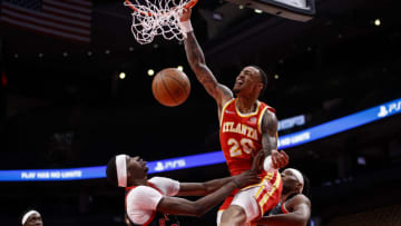 TORONTO, ON - FEBRUARY 04: John Collins #20 of the Atlanta Hawks dunks on Chris Boucher #25 of the Toronto Raptors during the first half of their NBA game at Scotiabank Arena on February 4, 2022 in Toronto, Canada. NOTE TO USER: User expressly acknowledges and agrees that, by downloading and or using this Photograph, user is consenting to the terms and conditions of the Getty Images License Agreement. (Photo by Cole Burston/Getty Images)