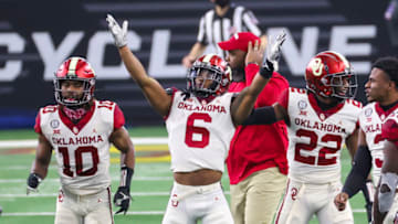 Dec 19, 2020; Arlington, Texas, USA; Oklahoma Sooners cornerback Tre Brown (6) reacts after making an interception during the fourth quarter against the Iowa State Cyclones at AT&T Stadium. Mandatory Credit: Kevin Jairaj-USA TODAY Sports