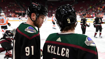 GLENDALE, ARIZONA - JANUARY 04: Taylor Hall #91 and Clayton Keller #9 of the Arizona Coyotes talk on the ice prior to the NHL hockey game against the Philadelphia Flyers at Gila River Arena on January 04, 2020 in Glendale, Arizona. (Photo by Norm Hall/NHLI via Getty Images)