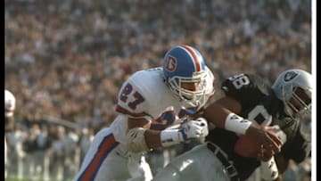 9 Jan 1994: Defensive back Steve Atwater of the Denver Broncos tackles Los Angeles Raiders tight end Ethan Horton during a playoff game at the Coliseum in Los Angeles, California. The Raiders won the game, 42-24. Mandatory Credit: Stephen Dunn /Allspor