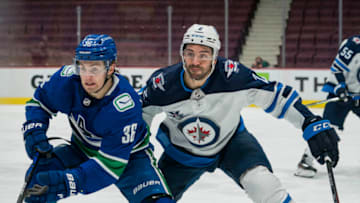 Mar 22, 2021; Vancouver, British Columbia, CAN; Winnipeg Jets defenseman Dylan DeMelo (2) skates against Vancouver Canucks forward Nils Hoglander (36) in the third period at Rogers Arena. Winnipeg won 4-0. Mandatory Credit: Bob Frid-USA TODAY Sports