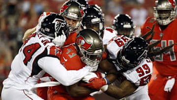 Nov 3, 2016; Tampa, FL, USA; Tampa Bay Buccaneers running back Peyton Barber (43) carries the ball as Atlanta Falcons outside linebacker Vic Beasley (44) and Falcons defensive end Adrian Clayborn (99) tackles during the first quarter at Raymond James Stadium. Mandatory Credit: Kim Klement-USA TODAY Sports
