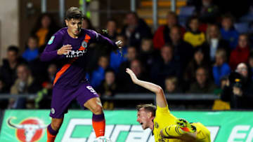OXFORD, ENGLAND - SEPTEMBER 25: Brahim Diaz of Manchester City takes the ball past Sam Long of Oxford United during the Carabao Cup Third Round match between Oxford United and Manchester City at Kassam Stadium on September 25, 2018 in Oxford, England. (Photo by Warren Little/Getty Images)