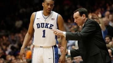 Feb 22, 2014; Durham, NC, USA; Duke Blue Devils head coach Mike Krzyzewski talks to forward Jabari Parker (1) on the sidelines against the Syracuse Orange at Cameron Indoor Stadium. Mandatory Credit: Mark Dolejs-USA TODAY Sports