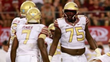 Aug 30, 2014; Arlington, TX, USA; Florida State Seminoles offensive tackle Cameron Erving (75) in game action against the Oklahoma State Cowboys at AT&T Stadium. Florida State beat Oklahoma State 37-31. Mandatory Credit: Tim Heitman-USA TODAY Sports