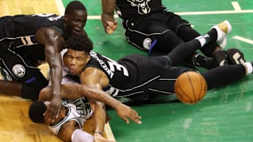 BOSTON, MA - APRIL 24: Marcus Smart #36 of the Boston Celtics competes for a loose ball against Giannis Antetokounmpo #34 of the Milwaukee Bucks and Thon Maker #7 during the fourth quarter in Game Five in Round One of the 2018 NBA Playoffs at TD Garden on April 24, 2018 in Boston, Massachusetts. The Celtics defeat the Bucks 92-87. (Photo by Maddie Meyer/Getty Images)