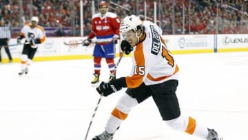 Feb 7, 2016; Washington, DC, USA; Philadelphia Flyers defenseman Michael Del Zotto (15) shoots the puck as Washington Capitals left wing Alex Ovechkin (8) looks on in the first period at Verizon Center. Mandatory Credit: Geoff Burke-USA TODAY Sports