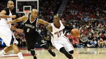 Apr 19, 2015; Atlanta, GA, USA; Atlanta Hawks guard Dennis Schroder (17) dribbles past Brooklyn Nets guard Jarrett Jack (0) during the second half in game one of the first round of the NBA Playoffs at Philips Arena. The Hawks defeated the Nets 99-92. Mandatory Credit: Dale Zanine-USA TODAY Sports