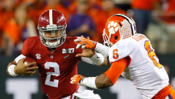 TAMPA, FL - JANUARY 09: Quarterback Jalen Hurts #2 of the Alabama Crimson Tide runs with the ball as linebacker Dorian O'Daniel #6 of the Clemson Tigers attempts to tackle him during the first half of the 2017 College Football Playoff National Championship Game at Raymond James Stadium on January 9, 2017 in Tampa, Florida. (Photo by Kevin C. Cox/Getty Images)