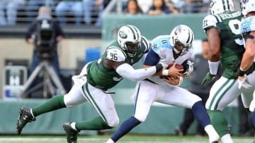 Dec 13, 2015; East Rutherford, NJ, USA; Tennessee Titans quarterback Marcus Mariota (8) is sacked by New York Jets defensive end Muhammad Wilkerson (96) during the second quarter at MetLife Stadium. Mandatory Credit: Brad Penner-USA TODAY Sports