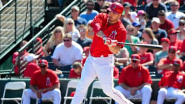 Mar 13, 2015; Tempe, AZ, USA; Los Angeles Angels left fielder Matt Joyce (20) hits a sacrifice fly in the first inning against the San Diego Padres at Tempe Diablo Stadium. Mandatory Credit: Matt Kartozian-USA TODAY Sports