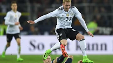 DORTMUND, GERMANY - MARCH 22: Julian Brandt of Germany is tackled by Eric Dier of England during the international friendly match between Germany and England at Signal Iduna Park on March 22, 2017 in Dortmund, Germany. (Photo by Shaun Botterill/Getty Images)