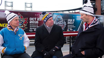 ST. LOUIS, MO - DECEMBER 15: St. Louis Blues Chairman Tom Stillman (L) St. Louis Blues radio announcer John Kelly, and St. Louis Cardinals President Bill DeWitt lll in front of the NHL's Winter Classic Ice Plant tractor trailer on December 15, 2016 at Busch Stadium in St. Louis, Missouri. The 53-foot tractor tailer will power the outdoor ice surface used for the 2017 Bridgestone NHL Winter Classic. (Photo by Scott Rovak/NHLI via Getty Images)
