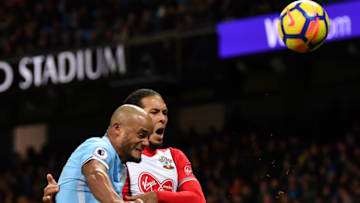 MANCHESTER, ENGLAND - NOVEMBER 29: Vincent Kompany of Manchester City clears the ball while under pressure from Virgil van Dijk of Southampton during the Premier League match between Manchester City and Southampton at Etihad Stadium on November 29, 2017 in Manchester, England. (Photo by Dan Mullan/Getty Images)