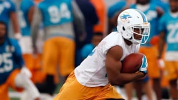 Jun 17, 2014; Davie, FL, USA; Miami Dolphins running back Daniel Thomas (33) runs with the ball during mini-camp at Miami Dolphins Training Facility. Mandatory Credit: Robert Mayer-USA TODAY Sports