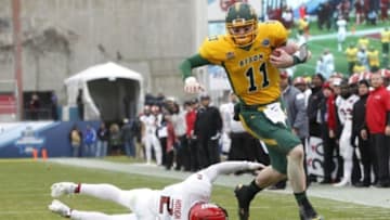 Jan 9, 2016; Frisco, TX, USA; North Dakota State Bison quarterback Carson Wentz (11) runs for a touchdown against Jacksonville State Gamecocks cornerback Jermaine Hough (2) in the second quarter in the FCS Championship college football game at Toyota Stadium. Mandatory Credit: Tim Heitman-USA TODAY Sports