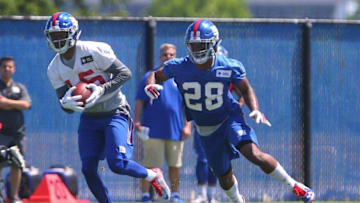 Jun 6, 2016; East Rutherford, NJ, USA; New York Giants wide receiver Tavarres King (15) catches a pass while being defended by New York Giants cornerback Eli Apple (28) during organized team activities at Quest Diagnostics Training Center. Mandatory Credit: Ed Mulholland-USA TODAY Sports