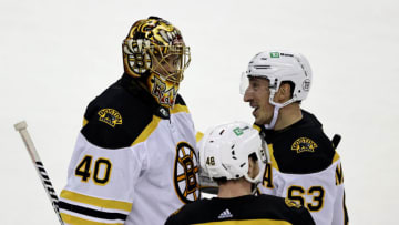 NEWARK, NEW JERSEY - JANUARY 14: Brad Marchand #63 of the Boston Bruins celebrates his game winning goal with teammates Tuukka Rask #40 and Matt Grzelcyk #48 in the shootout against the New Jersey Devils during the home opening game at Prudential Center on January 14, 2021 in Newark, New Jersey. The Boston Bruins defeated the New Jersey Devils 3-2 in a shootout. (Photo by Elsa/Getty Images)