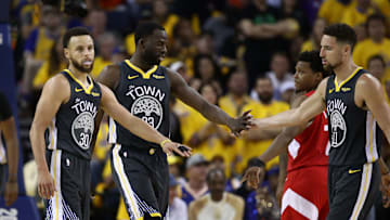 Stephen Curry (left) - Draymond Green - Klay Thompson (right)
