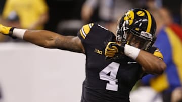 Dec 5, 2015; Indianapolis, IN, USA; Iowa Hawkeyes wide receiver Tevaun Smith (4) celebrates a touchdown during the third quarter against the Michigan State Spartans in the Big Ten Conference football championship game at Lucas Oil Stadium. Mandatory Credit: Brian Spurlock-USA TODAY Sports