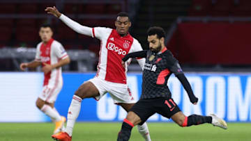 Liverpool's Egyptian forward Mohamed Salah (R) vies for the ball with Ajax's Dutch midfielder Ryan Gravenberch during the UEFA Champions League Group D first-leg football match between Ajax Amsterdam and Liverpool FC at the Johan Cruijff Arena in Amsterdam on October 21, 2020. (Photo by Kenzo Tribouillard / AFP) (Photo by KENZO TRIBOUILLARD/AFP via Getty Images)