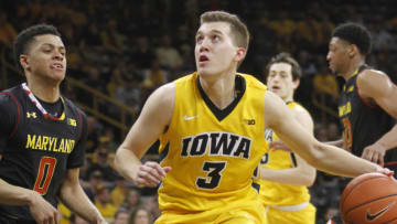 IOWA CITY, IA - JANUARY 19: Guard Jordan Bohannon #3 of the Iowa Hawkeyes drives to the basket in front of guard Anthony Cowan #0 of the Maryland Terrapins, in the second half on January 19, 2017 at Carver-Hawkeye Arena, in Iowa City, Iowa. (Photo by Matthew Holst/Getty Images)