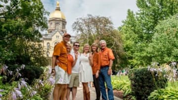 Sep 5, 2015; South Bend, IN, USA; Texas fans pose for photos in front of the Notre Dame Administration Building before the game between the Notre Dame Fighting Irish and the Texas Longhorns at Notre Dame Stadium. Mandatory Credit: Matt Cashore-USA TODAY Sports