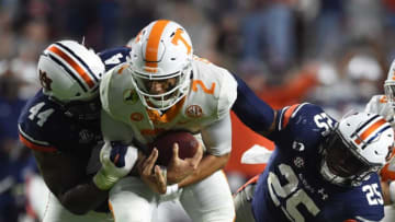 Auburn football defensive tackle DaQuan Newkirk (44) and defensive lineman Colby Wooden (25) grab ahold of Tennessee quarterback Jarrett Guarantano (2) as Auburn defensive lineman Derick Hall (29) is trampled over at Jordan-Hare Stadium in Auburn, Ala., on Saturday, Nov. 21, 2020.Auburn Ut