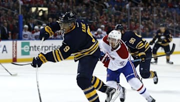 Mar 16, 2016; Buffalo, NY, USA; Buffalo Sabres left wing Evander Kane (9) takes a shot as Montreal Canadiens center Paul Byron (41) defends during the overtime period at First Niagara Center. The Canadiens beat the Sabres 3-2 in overtime. Mandatory Credit: Kevin Hoffman-USA TODAY Sports
