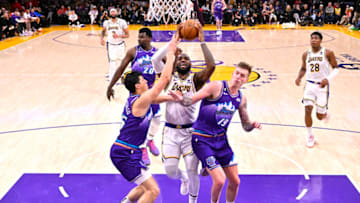Apr 9, 2023; Los Angeles, California, USA; Los Angeles Lakers forward LeBron James (6) drives through Utah Jazz forward Simone Fontecchio (16) and forward Luka Samanic (19) for a basket in the second half at Crypto.com Arena. Mandatory Credit: Jayne Kamin-Oncea-USA TODAY Sports
