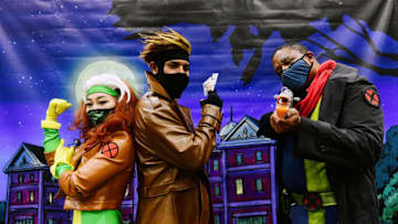 LOS ANGELES, CALIFORNIA - DECEMBER 03: Cosplayers pose at a booth at 2021 Los Angeles Comic Con at Los Angeles Convention Center on December 03, 2021 in Los Angeles, California. (Photo by Chelsea Guglielmino/Getty Images)