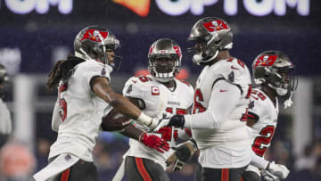 Oct 3, 2021; Foxboro, MA, USA; Tampa Bay Buccaneers cornerback Richard Sherman (5) and linebacker Devin White (45) and offensive tackle Donovan Smith (76) celebrate a turnover against the New England Patriots during the second half at Gillette Stadium. Mandatory Credit: Paul Rutherford-USA TODAY Sports