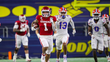 Dec 30, 2020; Arlington, TX, USA; Oklahoma Sooners running back Seth McGowan (1) runs past Florida Gators defensive back Donovan Stiner (13) during the second half at AT&T Stadium. Mandatory Credit: Kevin Jairaj-USA TODAY Sports