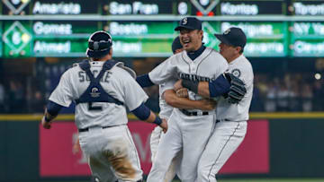 SEATTLE, WA - AUGUST 12: Starting pitcher Hisashi Iwakuma #18 (center) of the Seattle Mariners is congratulated by teammates after throwing a no-hitter to defeat the Baltimore Orioles 3-0 at Safeco Field on August 12, 2015 in Seattle, Washington. (Photo by Otto Greule Jr/Getty Images)