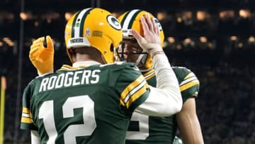 GREEN BAY, WISCONSIN - NOVEMBER 13: Aaron Rodgers #12 of the Green Bay Packers celebrates with Christian Watson #9 of the Green Bay Packers after scoring a touchdown during the fourth quarter against the Dallas Cowboys at Lambeau Field on November 13, 2022 in Green Bay, Wisconsin. (Photo by Patrick McDermott/Getty Images)