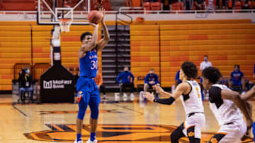 Jan 12, 2021; Stillwater, Oklahoma, USA; Kansas Jayhawks guard Ochai Agbaji (30) shoots the ball over Oklahoma State Cowboys guard Cade Cunningham (2) during the first half at Gallagher-Iba Arena. Mandatory Credit: Rob Ferguson-USA TODAY Sports