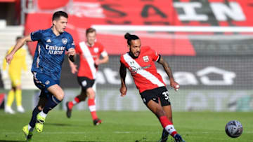 Southampton's English midfielder Theo Walcott (R) controls the ball during the English FA Cup fourth round football match between Southampton and Arsenal at St Mary's Stadium in Southampton, Hampshire,on January 23, 2021. (Photo by Ben STANSALL / AFP) / RESTRICTED TO EDITORIAL USE. No use with unauthorized audio, video, data, fixture lists, club/league logos or 'live' services. Online in-match use limited to 120 images. An additional 40 images may be used in extra time. No video emulation. Social media in-match use limited to 120 images. An additional 40 images may be used in extra time. No use in betting publications, games or single club/league/player publications. / (Photo by BEN STANSALL/AFP via Getty Images)