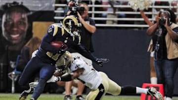 Aug 8, 2014; St. Louis, MO, USA; St. Louis Rams wide receiver Tavon Austin (11) breaks a tackle from New Orleans Saints defensive back Trevin Wade (30) during the first half at Edward Jones Dome. Mandatory Credit: Jeff Curry-USA TODAY Sports