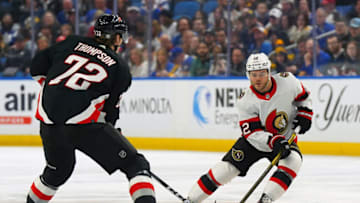 BUFFALO, NY - APRIL 13: Alex DeBrincat #12 of the Ottawa Senators skates up ice with the puck as Tage Thompson #72 of the Buffalo Sabres defends during the first period at KeyBank Center on April 13, 2023 in Buffalo, New York. (Photo by Kevin Hoffman/Getty Images)