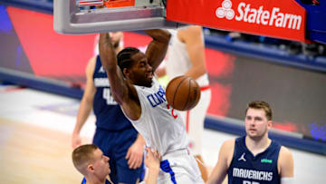 May 28, 2021; Dallas, Texas, USA; LA Clippers forward Kawhi Leonard (2) dunks the ball as Dallas Mavericks center Kristaps Porzingis (6) and guard Luka Doncic (77) look on during the second half in game three in the first round of the 2021 NBA Playoffs at American Airlines Center. Mandatory Credit: Jerome Miron-USA TODAY Sports